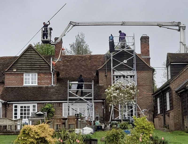 The Moss Cleaners using cherry picker and scaffolding to clean roof safely and professionally in Selsey, West Sussex